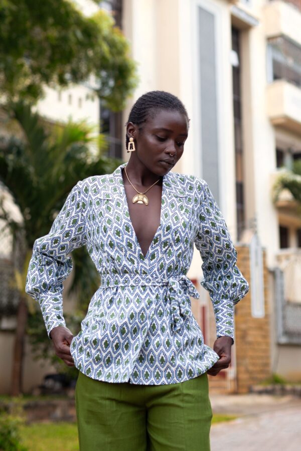 Charly wrap top with long cuffed bishop sleeves, made from hand block printed cotton. Versatile design with a detachable belt, tied around the front. 100% cotton, handmade in Kenya.